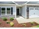 Charming front entrance with stone facade, and flower bed at 1701 Drayton Hall Ln, Sanford, NC 27330