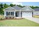 Beautiful single-story home with a two-car garage and a meticulously landscaped front yard at 1701 Drayton Hall Ln, Sanford, NC 27330