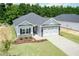 Charming single-story home featuring a stone-accented facade, a two-car garage, and a well-manicured lawn at 1701 Drayton Hall Ln, Sanford, NC 27330