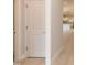 Hallway view looking into kitchen with white door and wood-look flooring at 1701 Drayton Hall Ln, Sanford, NC 27330