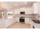 Modern kitchen with stainless steel appliances, white cabinets, and granite countertops at 1701 Drayton Hall Ln, Sanford, NC 27330