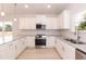 Well-equipped kitchen with white cabinets, stainless steel appliances, and granite countertops at 1701 Drayton Hall Ln, Sanford, NC 27330