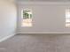 Bright living room with plush carpet, white trim, and natural light from double-hung windows at 1701 Drayton Hall Ln, Sanford, NC 27330