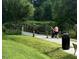 Scenic pathway leading to an arched bridge, surrounded by verdant foliage and natural beauty at 1701 Drayton Hall Ln, Sanford, NC 27330