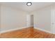 Simple bedroom with hardwood floors and door to closet at 1712 Rosetta Dr, Durham, NC 27701