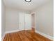 Well-lit bedroom featuring hardwood floors and double doors at 1712 Rosetta Dr, Durham, NC 27701