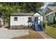 White house with blue steps and landscaping, located on a quiet street at 1712 Rosetta Dr, Durham, NC 27701
