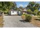 Cute white house with blue steps and gravel driveway at 1712 Rosetta Dr, Durham, NC 27701