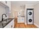 White cabinets, granite countertops, and stainless steel sink at 1712 Rosetta Dr, Durham, NC 27701