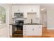 Updated kitchen with stainless steel appliances and white cabinets at 1712 Rosetta Dr, Durham, NC 27701