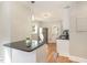 Modern kitchen with white cabinets, granite counters, and stainless steel appliances at 1712 Rosetta Dr, Durham, NC 27701