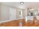 Bright living room with hardwood floors and view into kitchen at 1712 Rosetta Dr, Durham, NC 27701