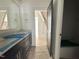 Double vanity bathroom featuring dark wood cabinets and white countertops at 1725 Burnette Garden Path, Raleigh, NC 27612