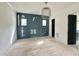 Stylish bedroom with black accent wall, wood floors, and a contemporary hanging light fixture at 1725 Burnette Garden Path, Raleigh, NC 27612