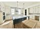 Bright, spacious kitchen with white cabinetry, a large island, and stainless steel appliances at 1725 Burnette Garden Path, Raleigh, NC 27612