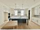 Bright, spacious kitchen with white cabinetry, a large island, and stainless steel appliances at 1725 Burnette Garden Path, Raleigh, NC 27612