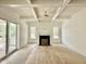 Open-concept living room with hardwood floors, a fireplace, and sliding glass doors to the deck at 1725 Burnette Garden Path, Raleigh, NC 27612