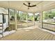 Outdoor screened porch area with wooden flooring, white ceilings, and a view of the backyard at 1725 Burnette Garden Path, Raleigh, NC 27612