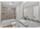 Bathroom with tub, shower, white vanity, and granite countertop at 201 Brickwell Way, Youngsville, NC 27596