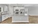 Modern kitchen with island, granite countertops, and stainless steel appliances at 201 Brickwell Way, Youngsville, NC 27596