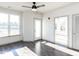 Bedroom with large window, sunroom access, and ceiling fan at 2325 Gathering Square Ct Ct # 2325, Fuquay Varina, NC 27526