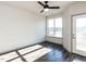 Bedroom with large window, balcony access, and ceiling fan at 2325 Gathering Square Ct Ct # 2325, Fuquay Varina, NC 27526