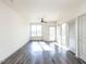 Bright living room with hardwood floors, large windows, and access to a balcony at 2325 Gathering Square Ct Ct # 2325, Fuquay Varina, NC 27526