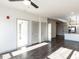 Sunlit living room features dark gray vinyl plank flooring at 2325 Gathering Square Ct Ct # 2325, Fuquay Varina, NC 27526