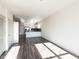 Sunlit living room features dark gray vinyl plank flooring at 2325 Gathering Square Ct Ct # 2325, Fuquay Varina, NC 27526