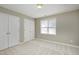 Bedroom with carpeted floors, natural light and double door closet at 2901 Alder Ridge Ln, Raleigh, NC 27603