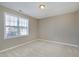 Neutral bedroom with a large window, wall-to-wall carpet and painted walls at 2901 Alder Ridge Ln, Raleigh, NC 27603