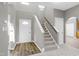Bright entryway with stairs, wood-look floors, and neutral walls at 2901 Alder Ridge Ln, Raleigh, NC 27603