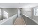 Upstairs hallway with carpet, access to bedrooms and bathroom at 2901 Alder Ridge Ln, Raleigh, NC 27603