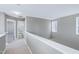Upper level hallway with carpet and doors to bedrooms and bath at 2901 Alder Ridge Ln, Raleigh, NC 27603