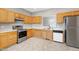 Kitchen boasts stainless steel appliances and wood cabinets at 2901 Alder Ridge Ln, Raleigh, NC 27603