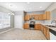 Kitchen and dining area with stainless steel appliances, wood cabinets, and ample natural light at 2901 Alder Ridge Ln, Raleigh, NC 27603