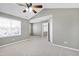 A large, carpeted main bedroom featuring a ceiling fan and lots of natural light at 2901 Alder Ridge Ln, Raleigh, NC 27603