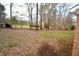 Spacious backyard with a mix of grass and trees at 315 Lakeshore Dr, Hillsborough, NC 27278