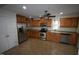 Modern kitchen with stainless steel appliances and wood cabinets at 315 Lakeshore Dr, Hillsborough, NC 27278