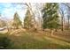 Spacious side yard with mature trees and grassy area at 315 Lakeshore Dr, Hillsborough, NC 27278
