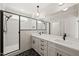 Bathroom features a double vanity, large mirror, sleek black fixtures, and glass-enclosed shower at 320 Pilot Ridge Rd, Zebulon, NC 27597