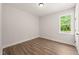 Bedroom with a window providing natural light and showcasing the wood-look flooring at 320 Pilot Ridge Rd, Zebulon, NC 27597