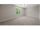 Bedroom features soft carpeting, a large window overlooking lush trees, and neutral wall paint at 320 Pilot Ridge Rd, Zebulon, NC 27597