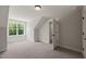 Bedroom with soft carpeting, a window with tree views, and an open doorway at 320 Pilot Ridge Rd, Zebulon, NC 27597