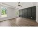The bedroom features two windows and a panel accent wall at 320 Pilot Ridge Rd, Zebulon, NC 27597