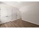 Bedroom with wood-look flooring, showcasing the closet and a view into the hallway at 320 Pilot Ridge Rd, Zebulon, NC 27597