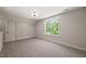 Bedroom showcasing a large window with a view of lush trees and soft carpeting at 320 Pilot Ridge Rd, Zebulon, NC 27597