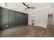 Spacious bedroom featuring a ceiling fan, tray ceiling, and a stylish gray accent wall with geometric trim at 320 Pilot Ridge Rd, Zebulon, NC 27597