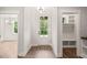Bright entryway showcasing beautiful wood floors, a modern light fixture, and convenient built-in storage at 320 Pilot Ridge Rd, Zebulon, NC 27597