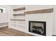 The fireplace is surrounded by white tile and has a wooden mantel and shelves at 320 Pilot Ridge Rd, Zebulon, NC 27597
